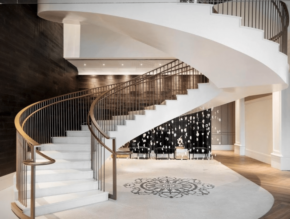white marble spiral staircase in a hotel lobby
